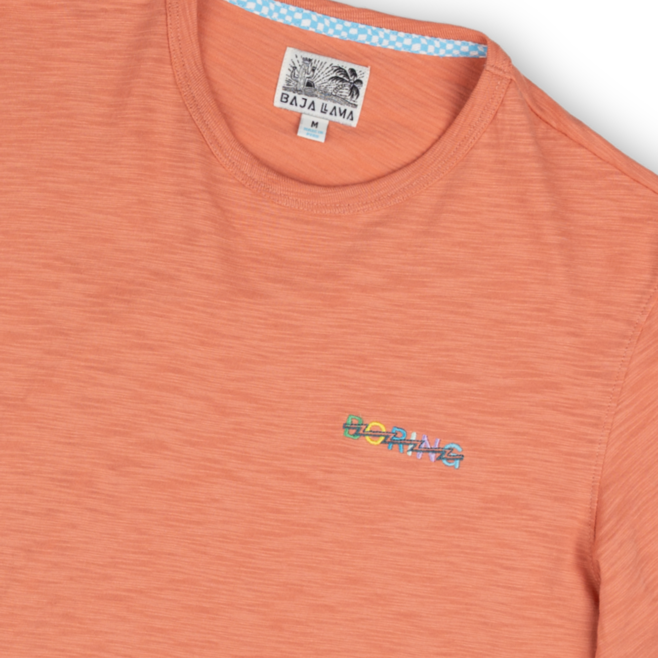 Lightweight burnt orange slub tee with a small embroidered detail. Soft, breathable fabric for all-day comfort.