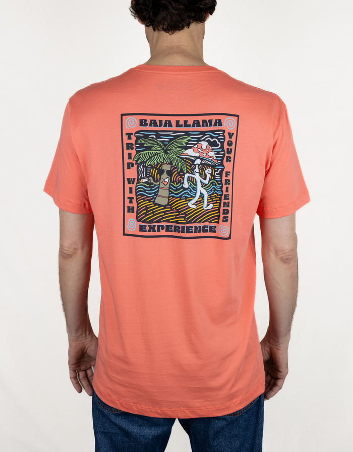 Back lifestyle view of coral Trip With Your Friends Primo tee showing psychedelic mushroom palm print