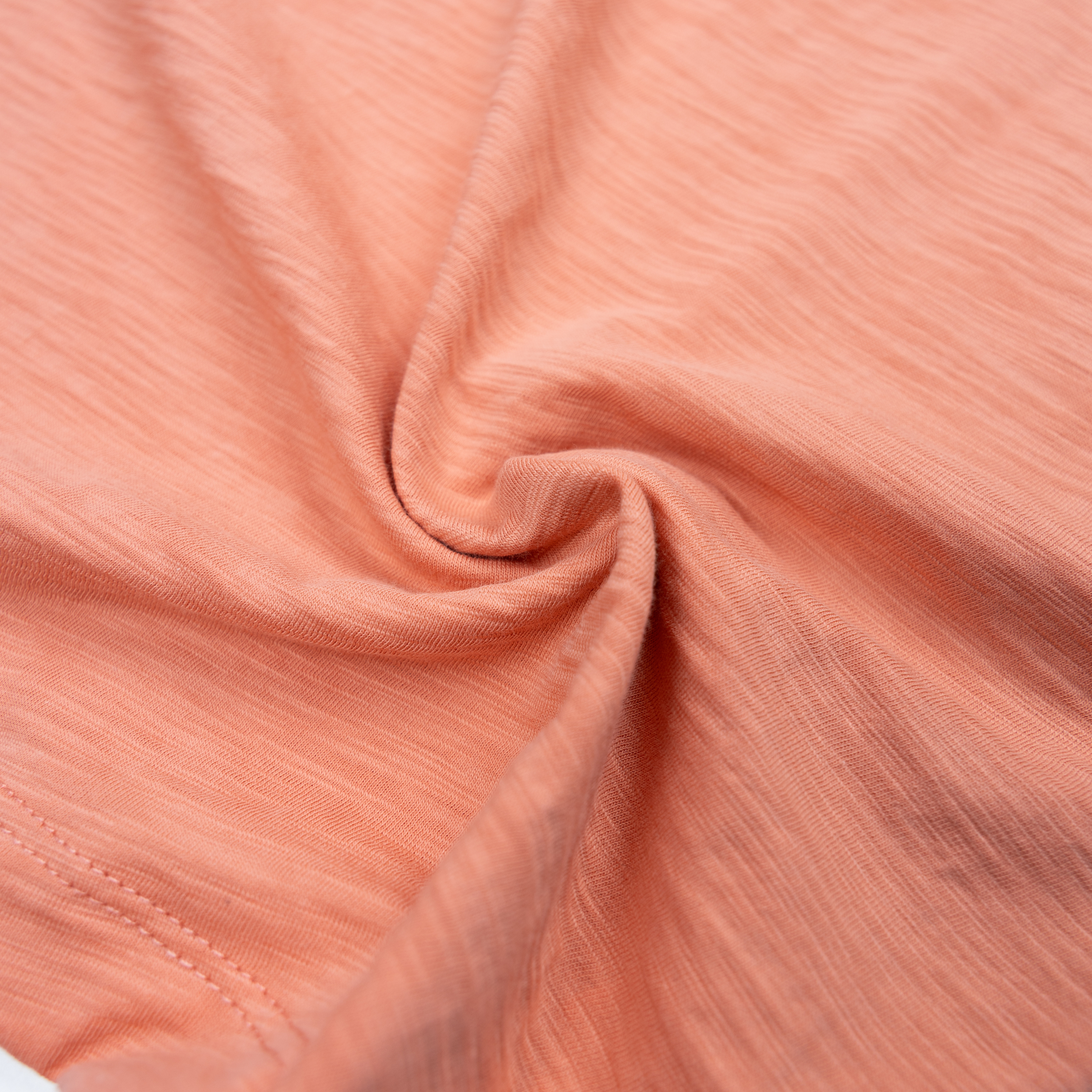 Baja Llama Solid Burnt Coral Slub Pima Tee – Burnt salmon crewneck T-shirt made from ultra-premium Peruvian cotton with textured slub finish – Close-up of fabric showcasing softness, breathability, and rich color – Eco-friendly, lightweight casual wear for men