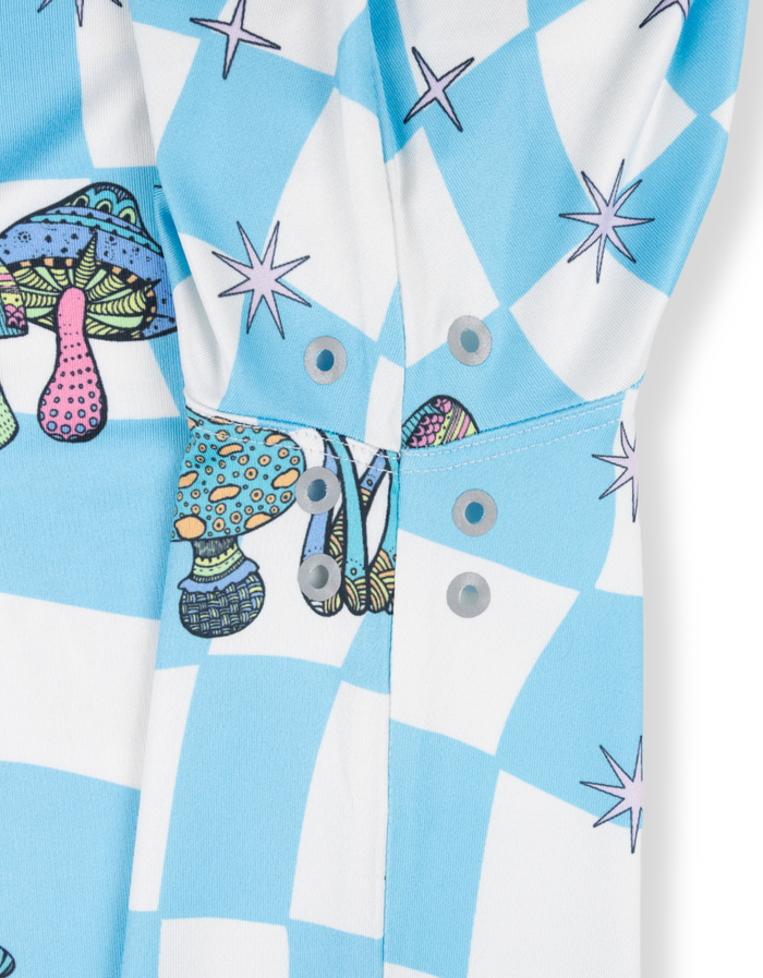Close-up detail of the Baja Llama Trip of a Lifetime Swingers Performance Polo, highlighting the underarm ventilation eyelets on the blue checkered mushroom-print fabric.