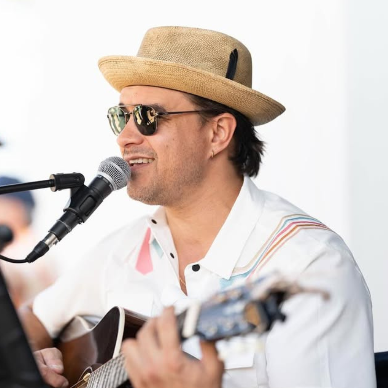 Musician performing live in Baja Llama Retro Rays Cream Dissident Western Snap Button-Up shirt.