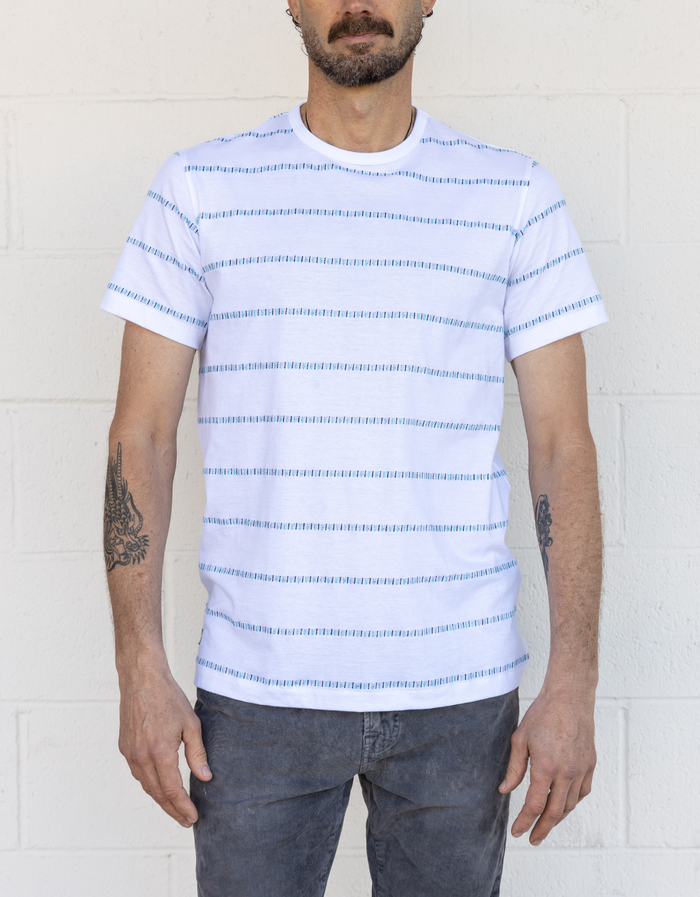 Front studio view of ivory Morris Code Onassis jacquard tee with teal dash horizontal stripe rows