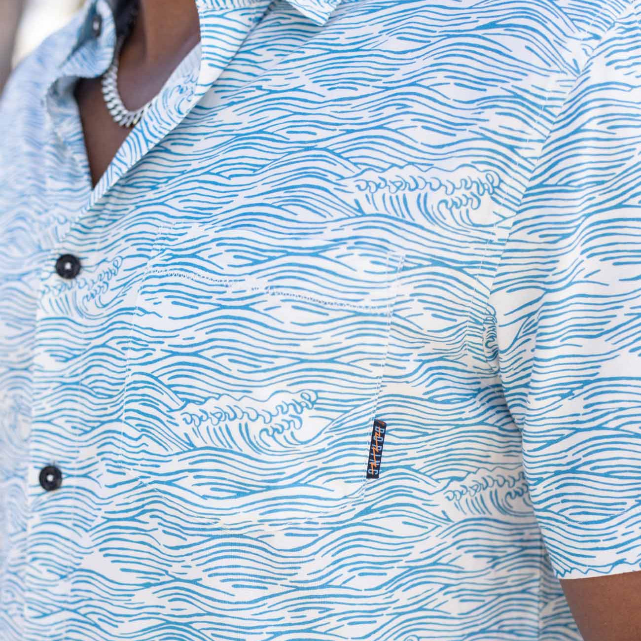 Light blue button up shirt with wave print and hidden side zipper pocket
