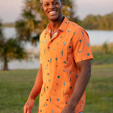 Button up shirt with hand painted watercolor cactus design on orange background.