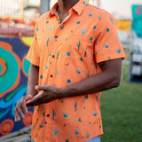Button up shirt with hand painted watercolor cactus design on orange background.