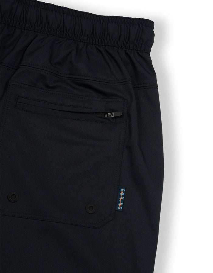 Close-up of the back pocket and label detail on the black Baja Llama Relaxplorations athleisure shorts.