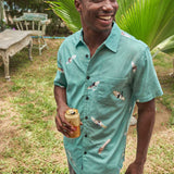 Button up shirt featuring overhead view of surfers and paddleboarders with paint effect.