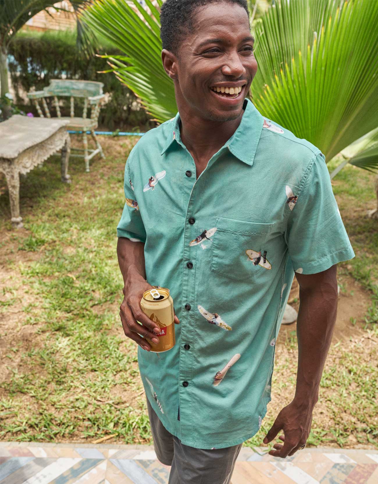 Button up shirt featuring overhead view of surfers and paddleboarders with paint effect.