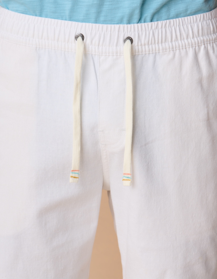 Close-up of white linen pants with a drawstring