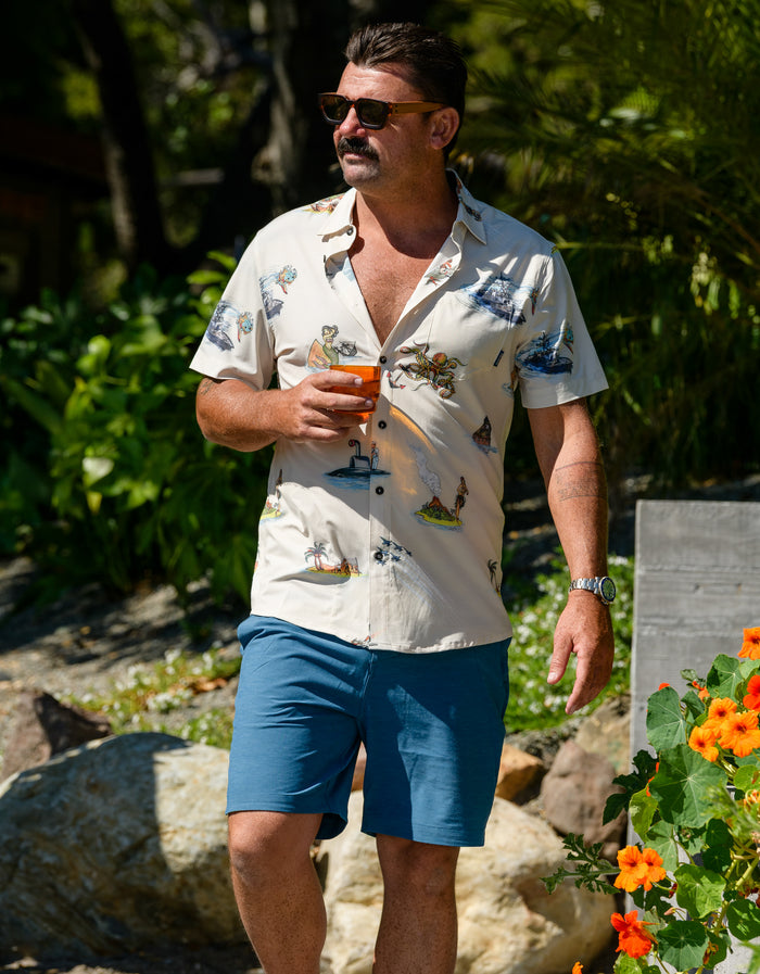 Baja Llama Magellan Explorer Mallard Blue Shorts, lifestyle portrait of men's hybrid shorts worn in a sunny outdoor setting.
