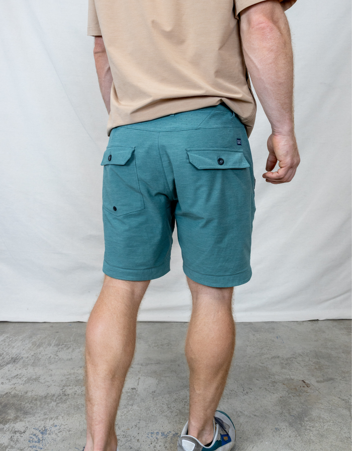 Back view of the Baja Llama Magellan Explorer Shorts in Hunter Green, featuring dual rear flap pockets and a durable hybrid design.