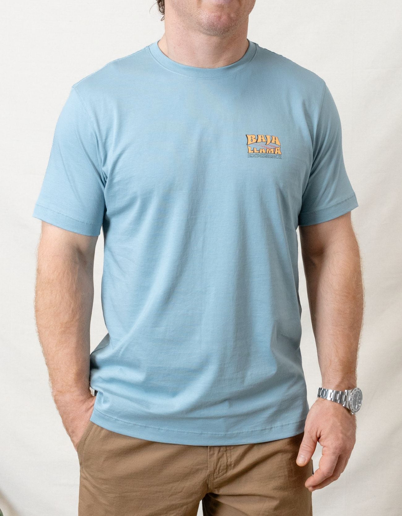 Bus Experience graphic tee by Baja Llama. Light teal tee with a retro bus design. Soft fabric and relaxed fit, perfect for laid-back, adventurous style.