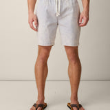 Person wearing acid wash cotton gray shorts with a drawstring on a plain background