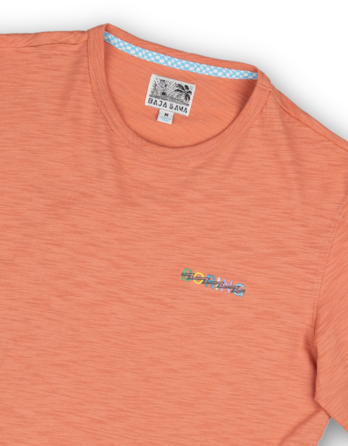 Chest close-up of salmon Boring Embroidery Slub Pima tee showing colorful BORING stitch graphic