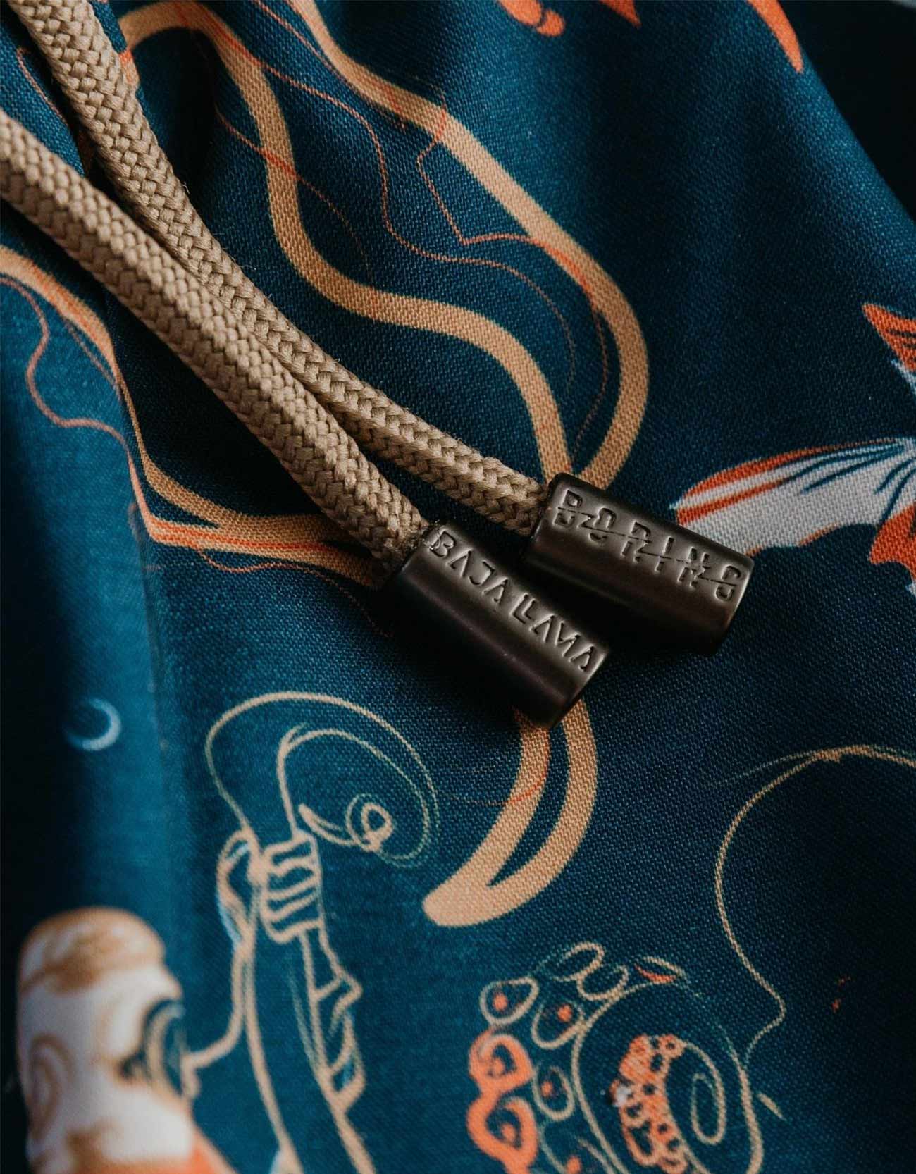 Navy men's volley swim trunks featuring ocean creatures like fish varieties and octopus. 
