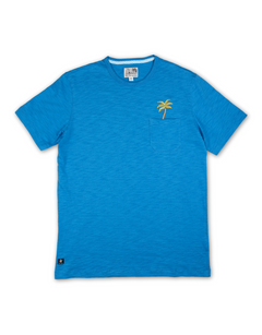 A blue t-shirt with a small embroidered palm tree design on the chest pocket area.