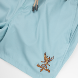 Men’s light blue swim shorts with retro-style orange and white side stripes, black elastic waistband, and adjustable drawstring. Features embroidered Baja Llama scorpion design and quick-dry fabric for all-day comfort.