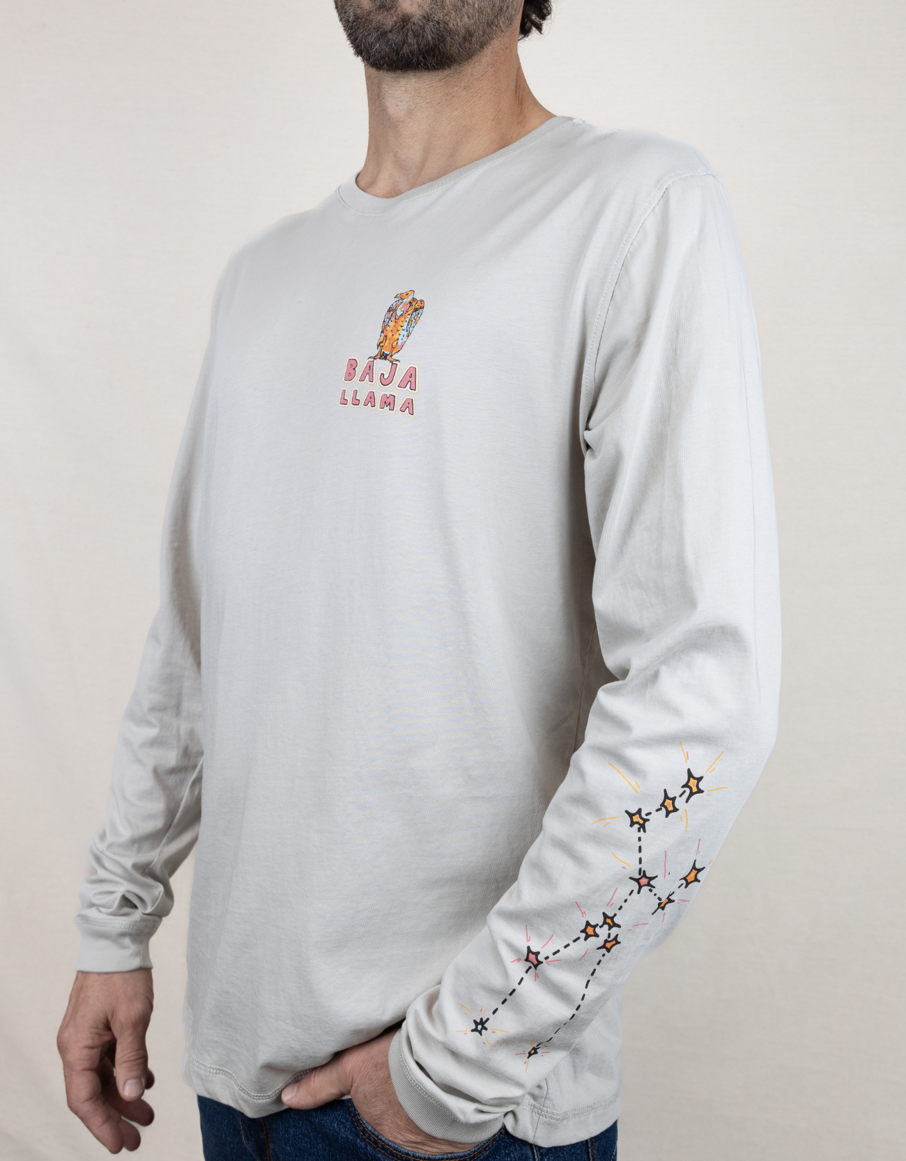 Baja Llama light desert-themed long sleeve tee with snake and Joshua tree back graphic. Soft cotton with printed sleeve details.