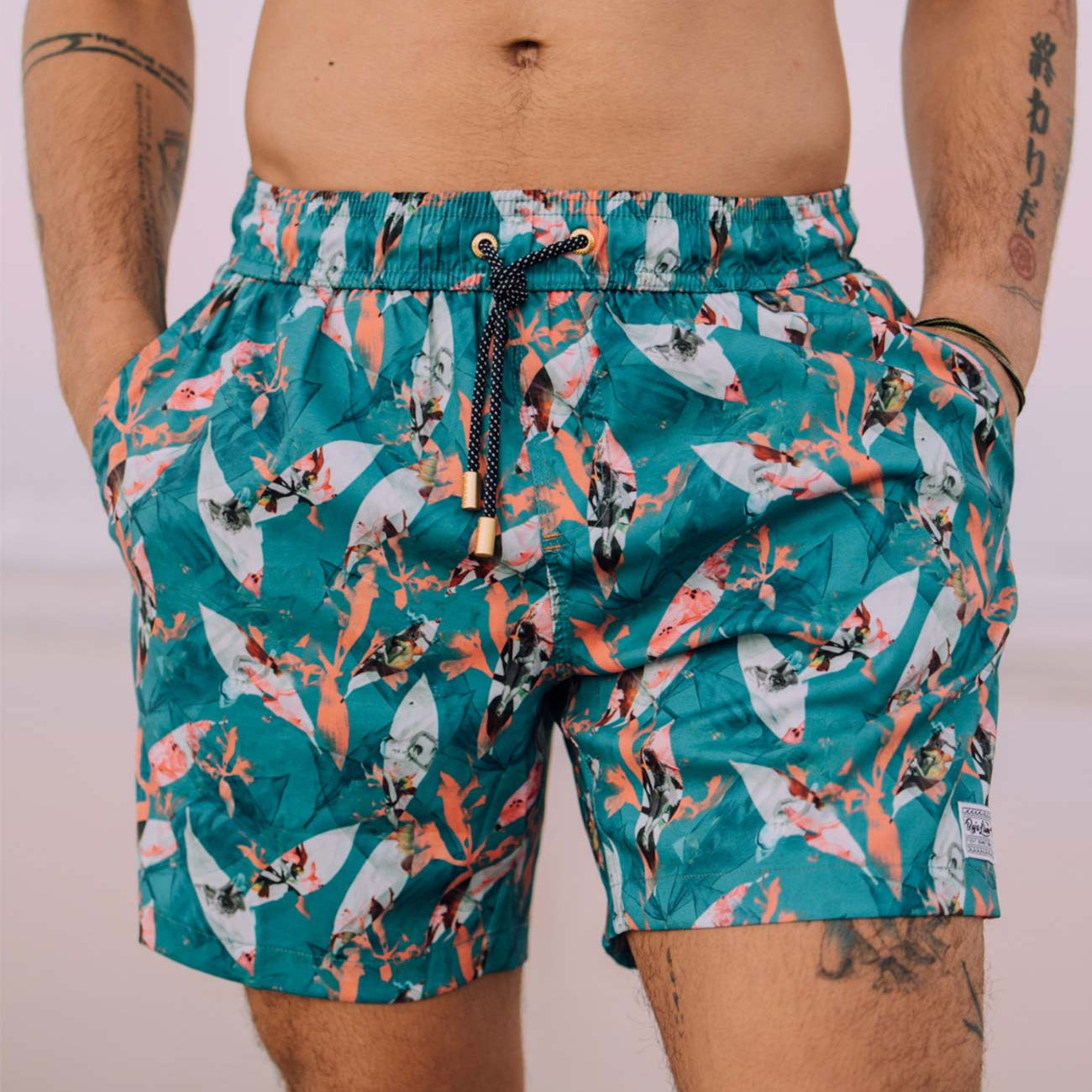 Turquoise floral men's volley shorts with retro print of woman surfing.