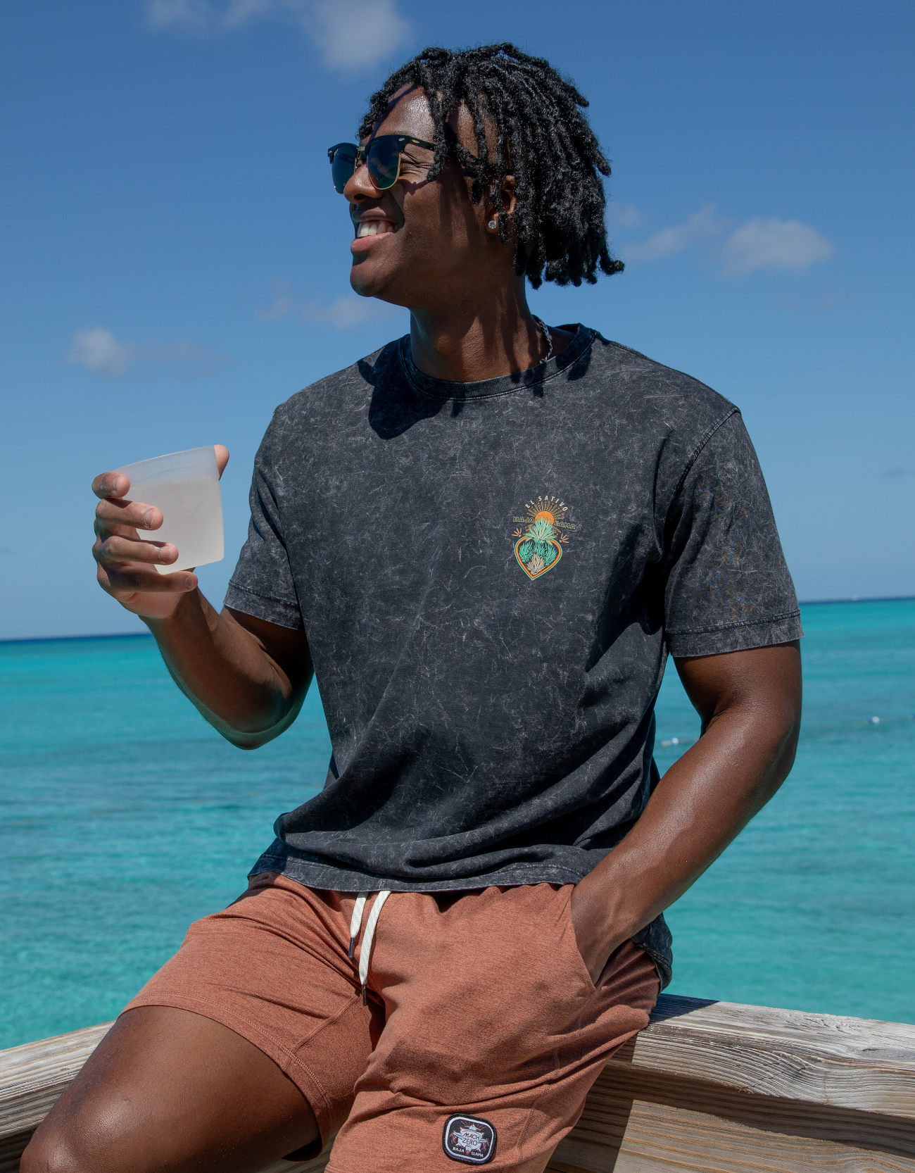 Agave El Sativo acid wash black graphic tee by Baja Llama. Collaboration with El Sativo organic tequila featuring a bold teal agave plant with El Sativo branding. Soft fabric and relaxed fit for adventurous style.