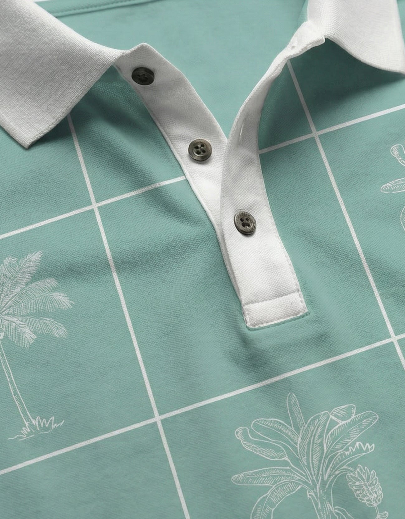 An extreme close-up of the Baja Llama La Republica Piscina Palm Green Swingers Performance Polo, detailing the textured white collar, a three-button placket with dark buttons, and the white grid with sketched palm trees.