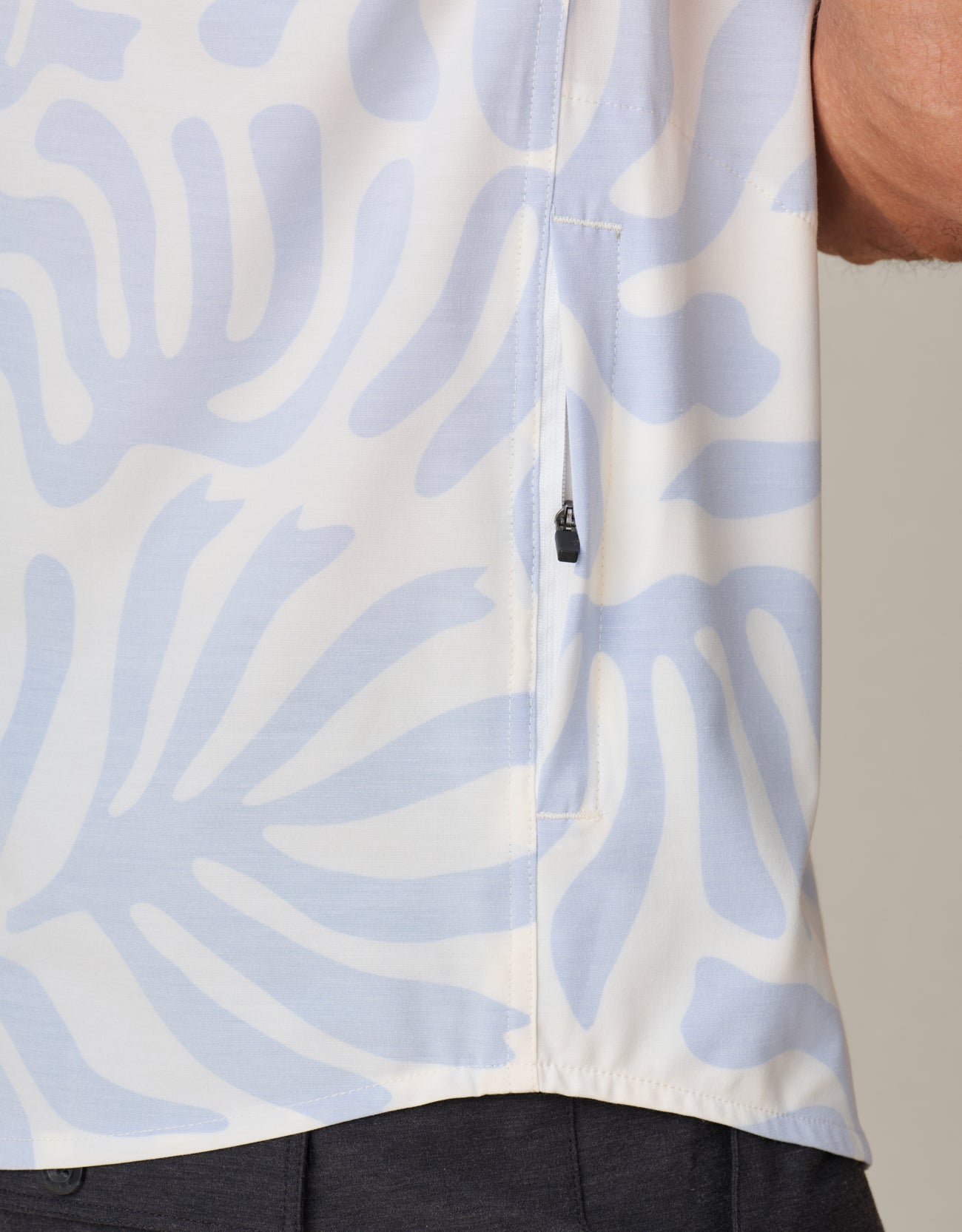 Hidden zipper pocket detail on recycled fabric shirt