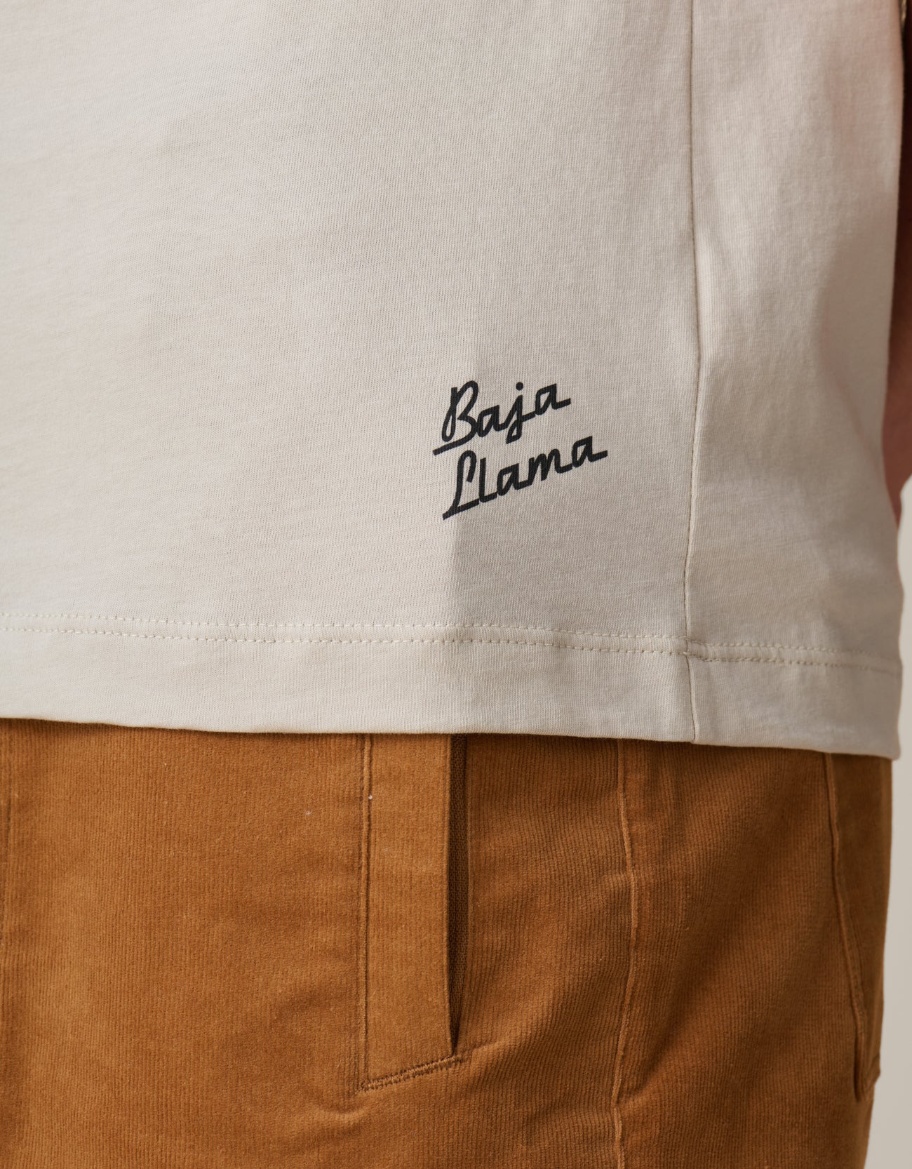 Baja Llama logo on the Village Idiots Primo Graphic Tee