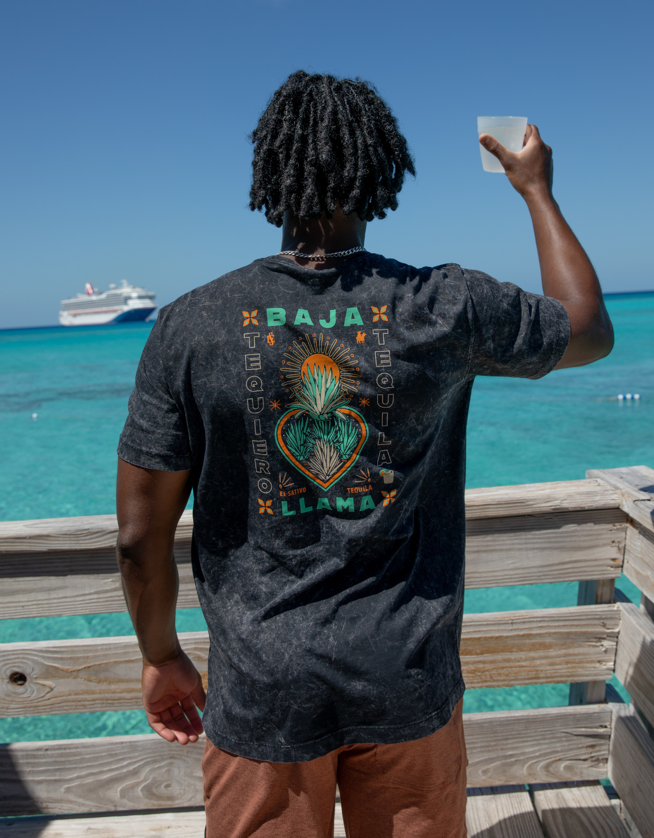 Agave El Sativo acid wash black graphic tee by Baja Llama. Collaboration with El Sativo organic tequila featuring a bold teal agave plant with El Sativo branding. Soft fabric and relaxed fit for adventurous style.