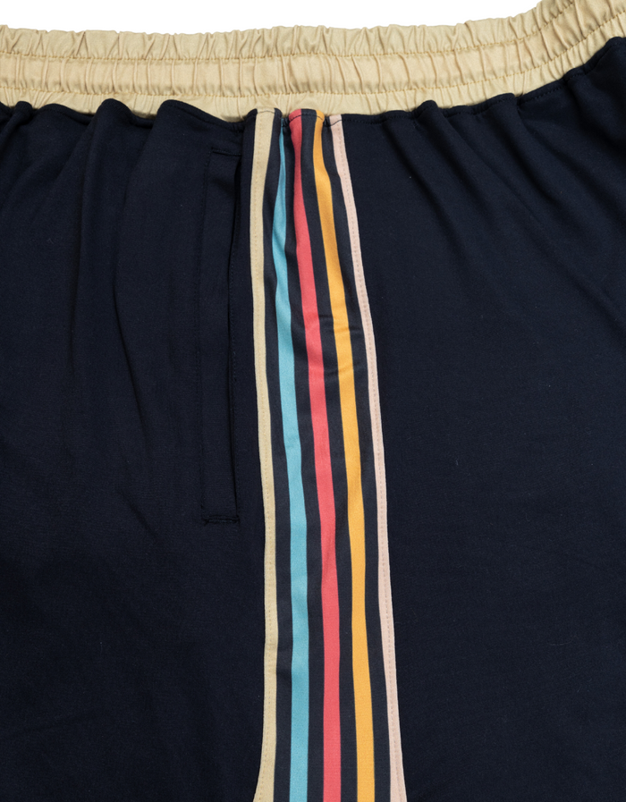 Close-up of the Baja Llama Mach Zero lounge shorts in retro black, highlighting the multi-colored racing stripe detail along the side.