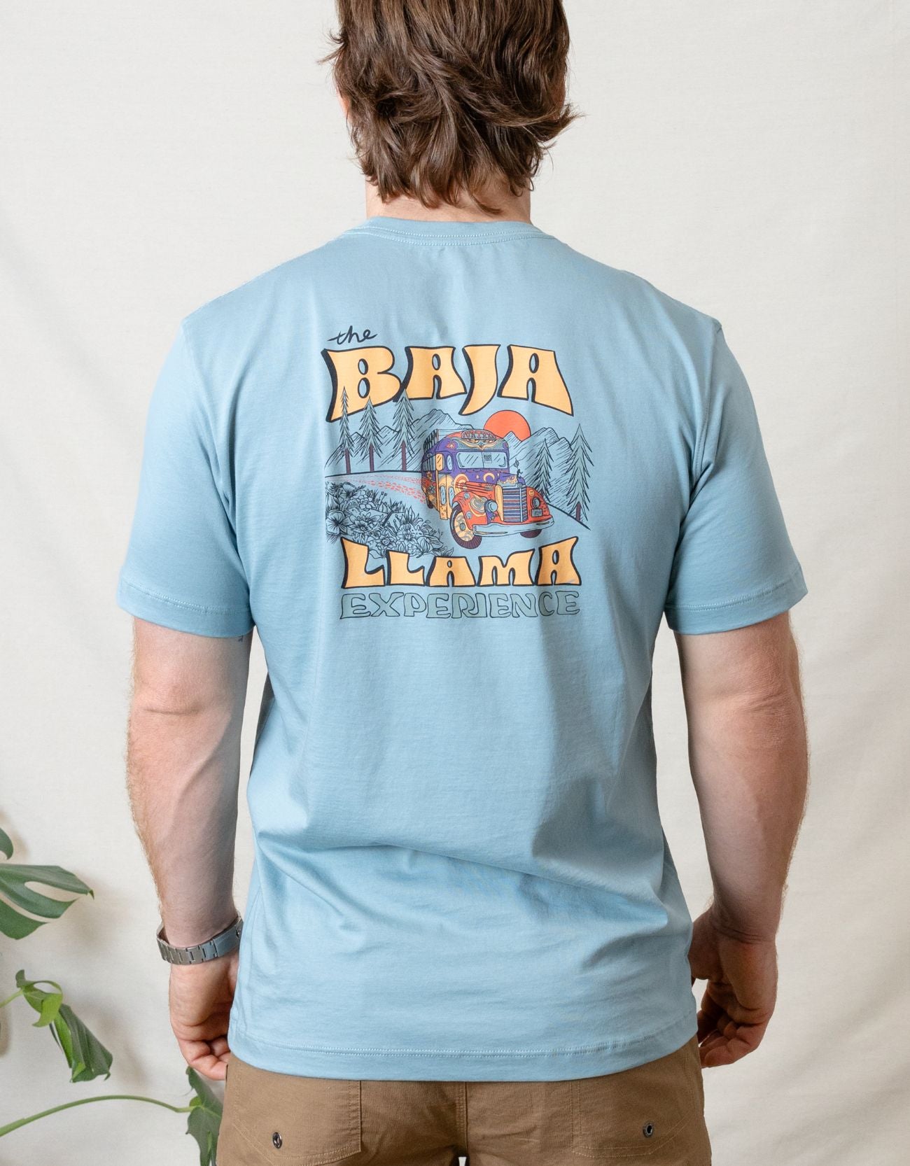 Bus Experience graphic tee by Baja Llama. Light teal tee with a retro bus design. Soft fabric and relaxed fit, perfect for laid-back, adventurous style.