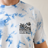 Wavy Dayz blue tie-dye graphic tee by Baja Llama. Features a vibrant, swirling tie-dye pattern with tropical ocean graphic on the front. Soft, comfortable fabric and relaxed fit, perfect for casual, adventurous style.