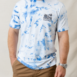 Wavy Dayz blue tie-dye graphic tee by Baja Llama. Features a vibrant, swirling tie-dye pattern with tropical ocean graphic on the front. Soft, comfortable fabric and relaxed fit, perfect for casual, adventurous style.