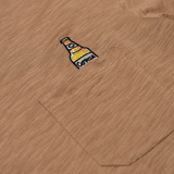close up shot of the the beer embroidery logo on the shirt pocket.