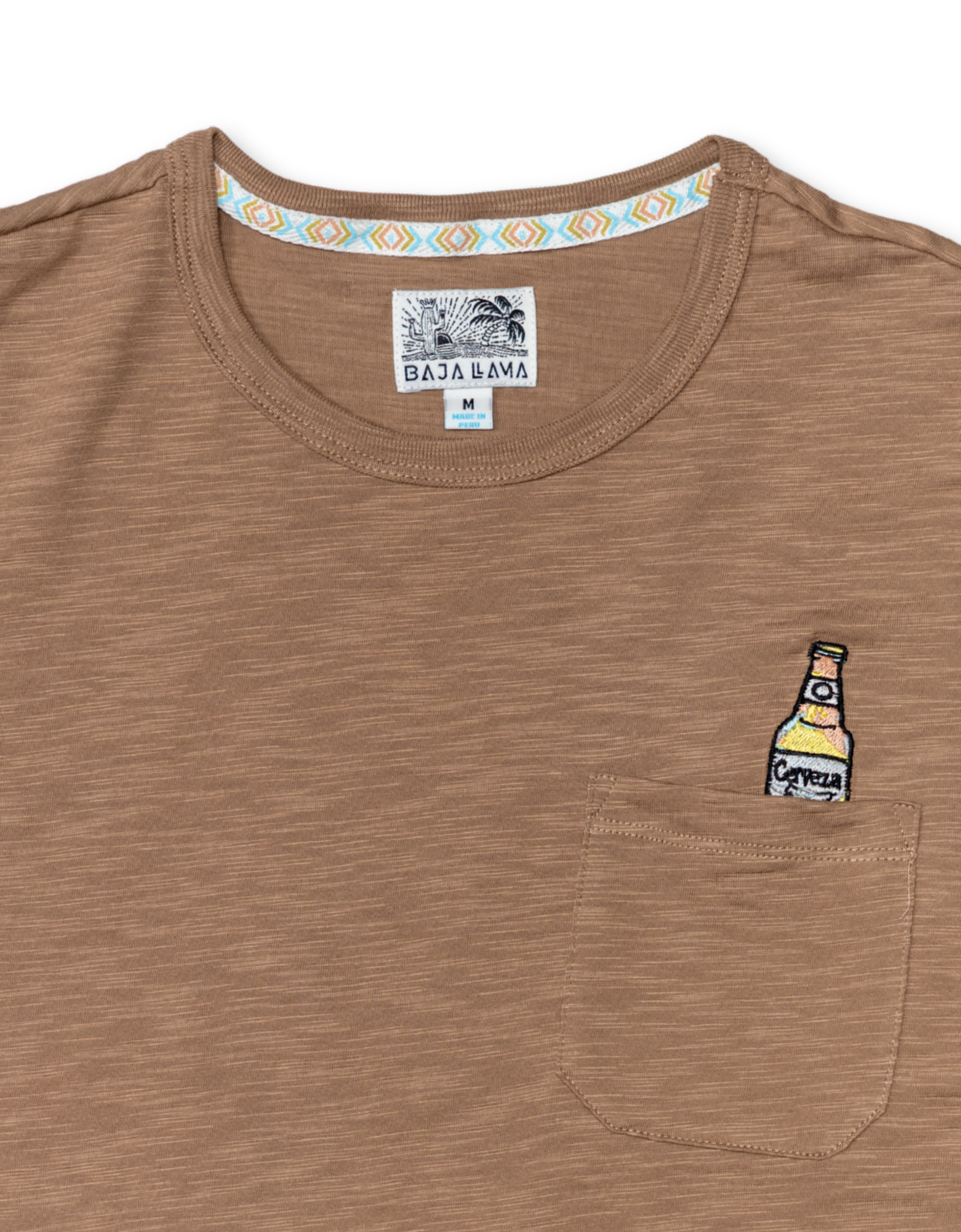 close up shot of the shirt neckline showing the Baja Llama logo and the embroidery on the chest pocket.