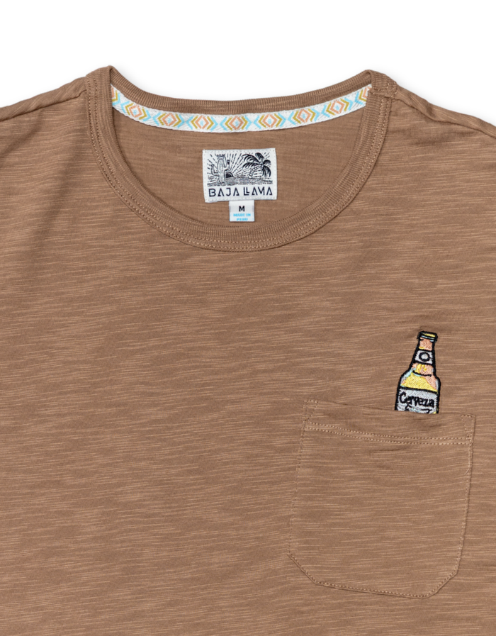 close up shot of the shirt neckline showing the Baja Llama logo and the embroidery on the chest pocket.