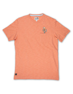 Baja Llama Cactus Hat Slub Pima Pocket Tee in orange, featuring a cactus wearing a cowboy hat embroidered detail peeking out of the front pocket.