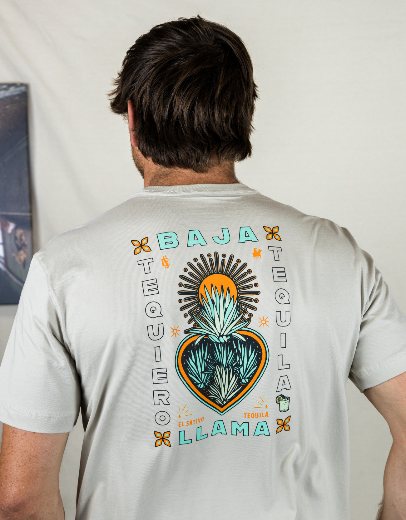 Cream graphic tee with teal El Sativo Tequila elements, featuring a detailed agave plant design. Soft and comfortable with a bold, artistic touch for a stylish, casual look.