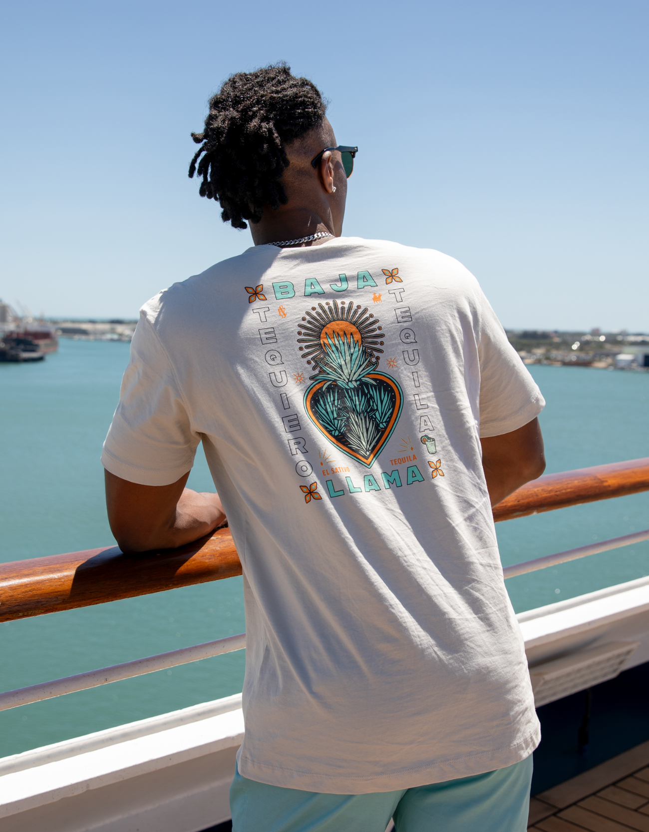 Cream graphic tee with teal El Sativo Tequila elements, featuring a detailed agave plant design. Soft and comfortable with a bold, artistic touch for a stylish, casual look.