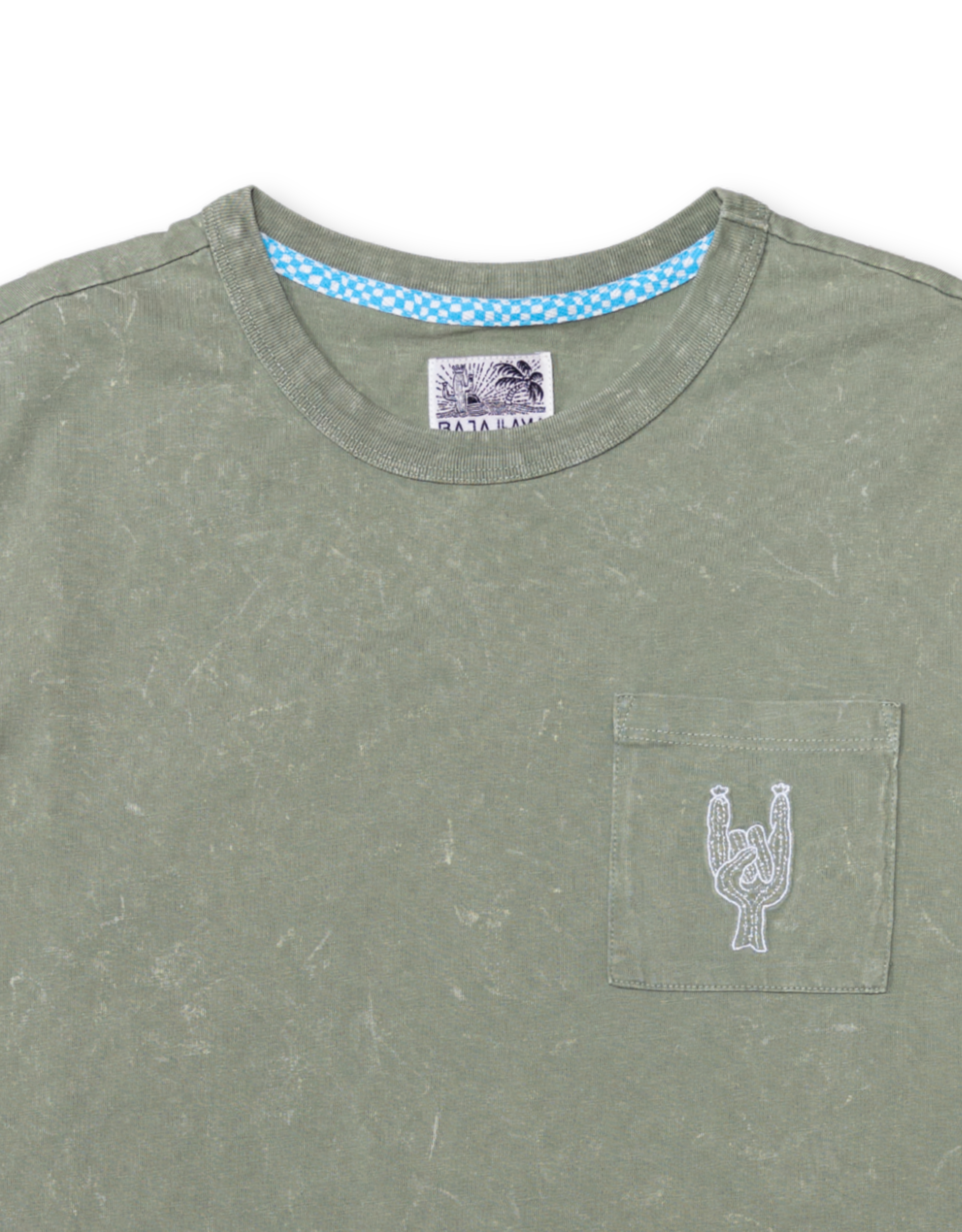 Close-up of the collar and chest area of the Baja Llama Greatful Dyed Rock On Cypress Green Heavy Tee, showing the crew neck, a blue checkered inner neck tape, and a chest pocket with white embroidered rock-on sign cactus