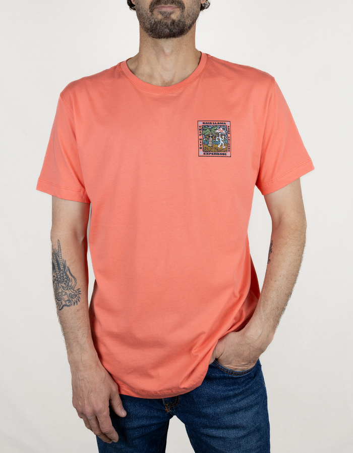 Baja Llama Trip With Your Friends Primo Graphic Tee in coral, front view showing the small chest graphic on the t-shirt.