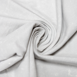 Detailed shot of the Baja Llama Greatful Dyed Shoreline Smoke Heavy Tee fabric, tightly swirled to showcase its heavy cotton texture and vintage-wash light gray color.