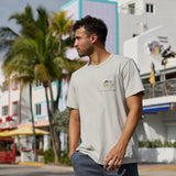 Man wearing the Greatful Dyed Shoreline Smoke Heavy Tee by Baja Llama with front pocket detail, outdoor lifestyle shot