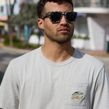 Model wearing the Greatful Dyed Shoreline Smoke Heavy Tee by Baja Llama with close-up of pocket logo and sunglasses