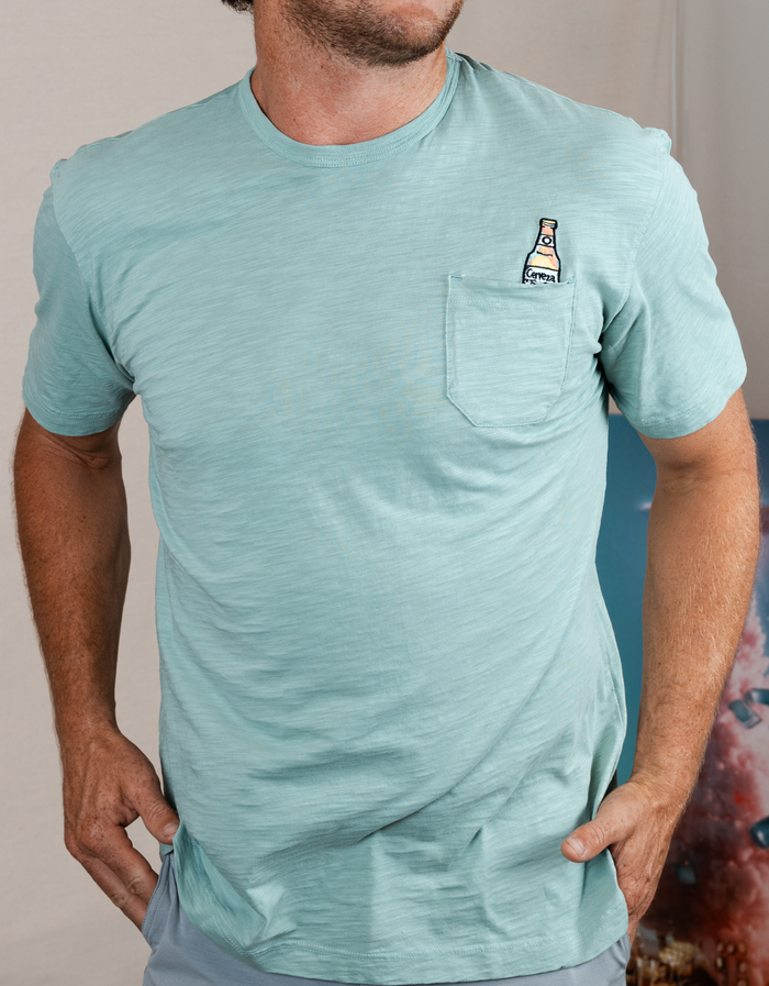 Torso studio view of seafoam Cerveza Slub Pima pocket tee with beer bottle pocket embroidery