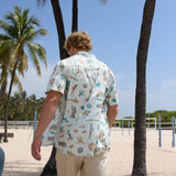 Man wearing Baja Llama La Republica Bananera Icy Mint 7-Seas Relaxed Fit Button Up shirt from behind at the beach