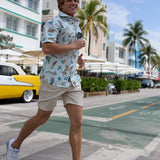 Man wearing Baja Llama La Republica Bananera Icy Mint 7-Seas Relaxed Fit Button Up shirt jogging on a sunny street
