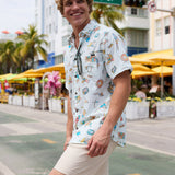 Smiling man walking on a city street wearing Baja Llama La Republica Bananera Icy Mint 7-Seas Relaxed Fit Button Up shirt