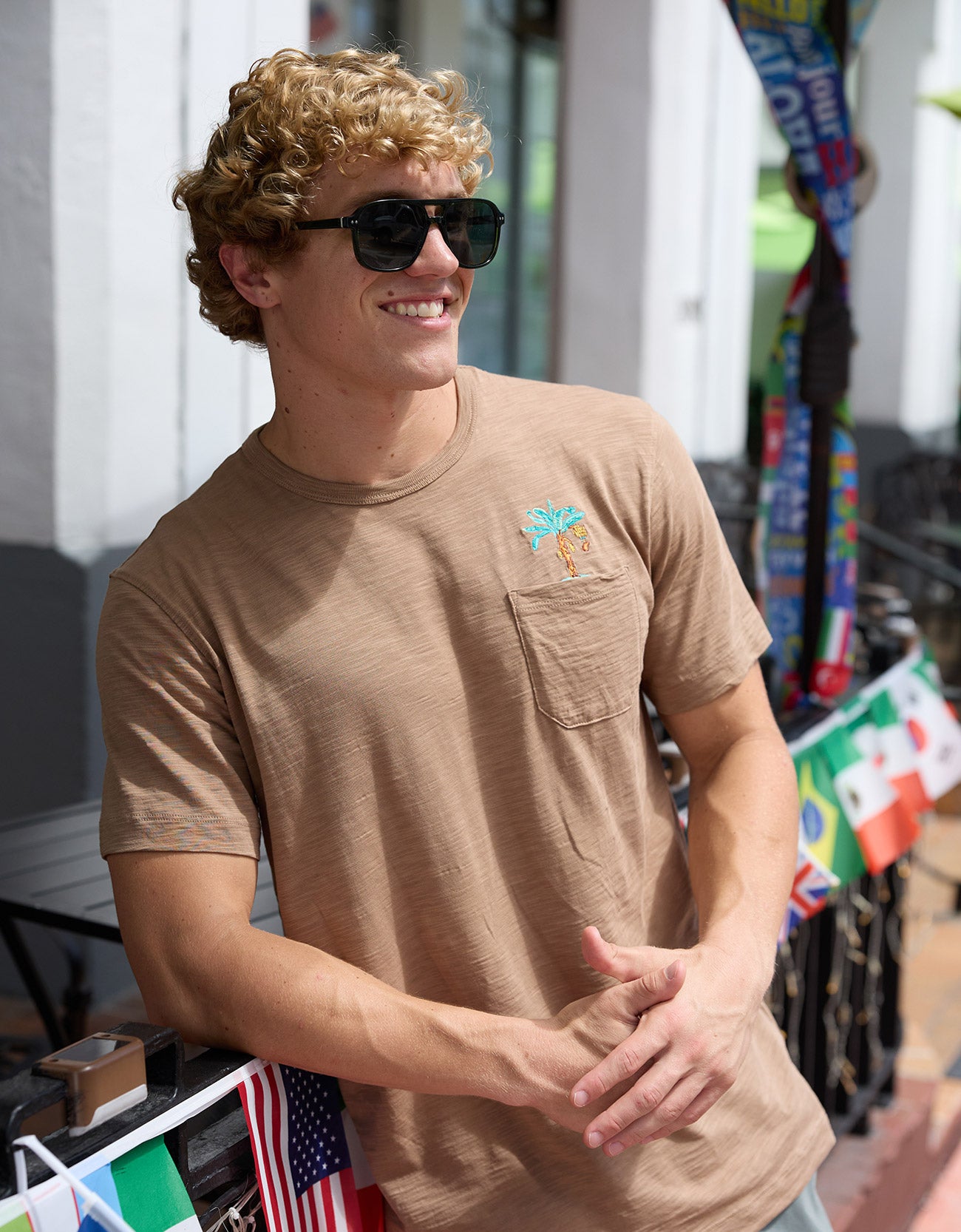 Man wearing Baja Llama La Republica Embroidered Pima Slub Pocket Tee outdoor lifestyle portrait with sunglasses