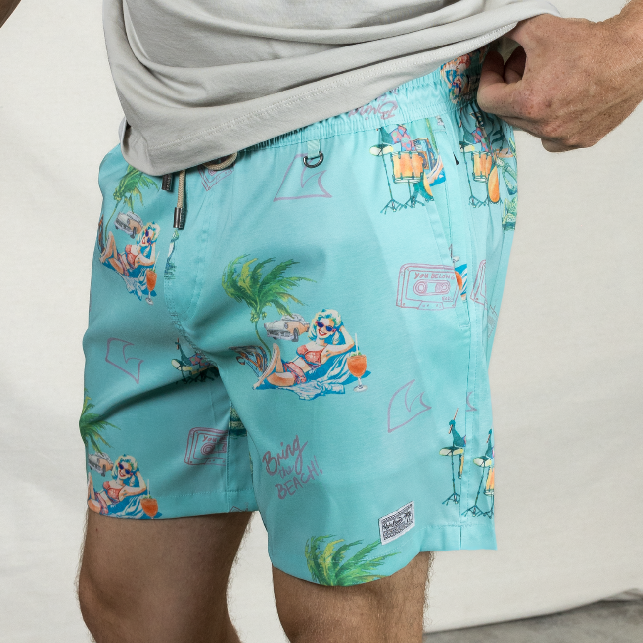 Men's light teal green swimsuit, a collaboration with the band The 502s. Featuring fun Florida-inspired vibes with playful, beachy designs. Perfect for summer adventures and laid-back style.