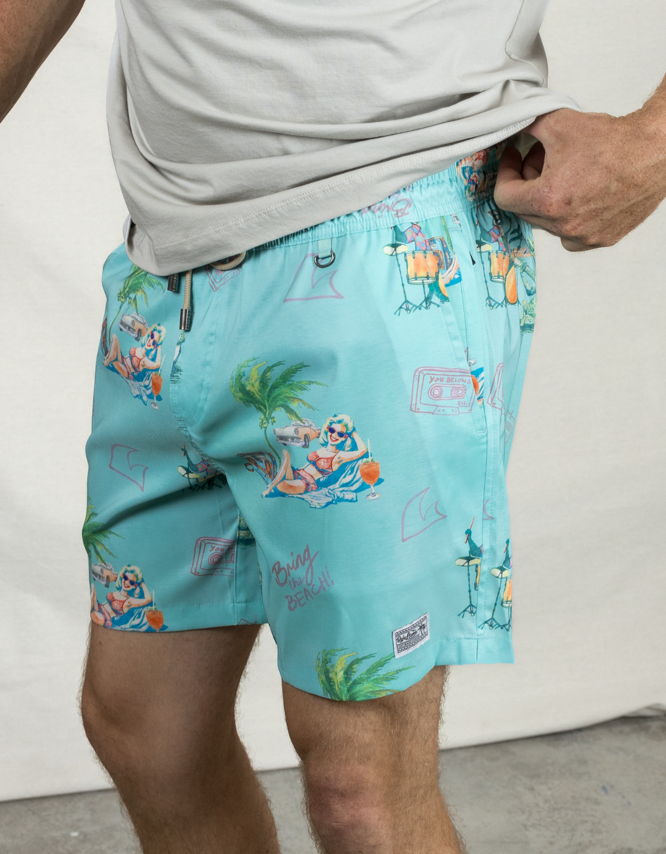 Men's light teal green swimsuit, a collaboration with the band The 502s. Featuring fun Florida-inspired vibes with playful, beachy designs. Perfect for summer adventures and laid-back style.